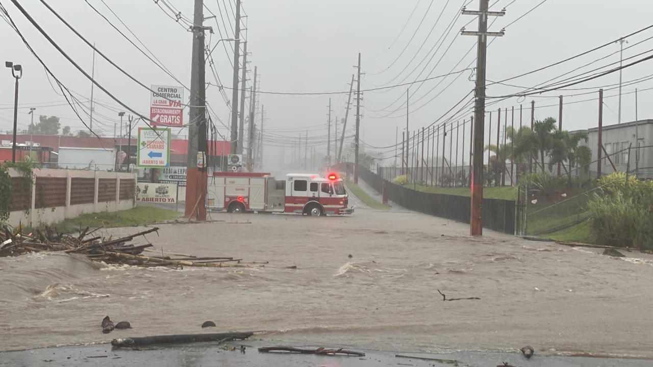 firetruck driving through floodwater and hurricane