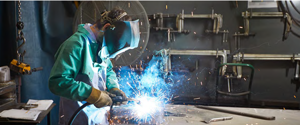 A person welding with protective gear on