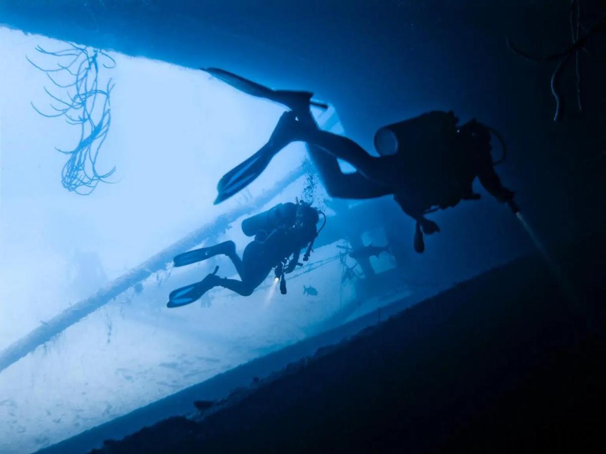 Two scuba divers in an underwater structure