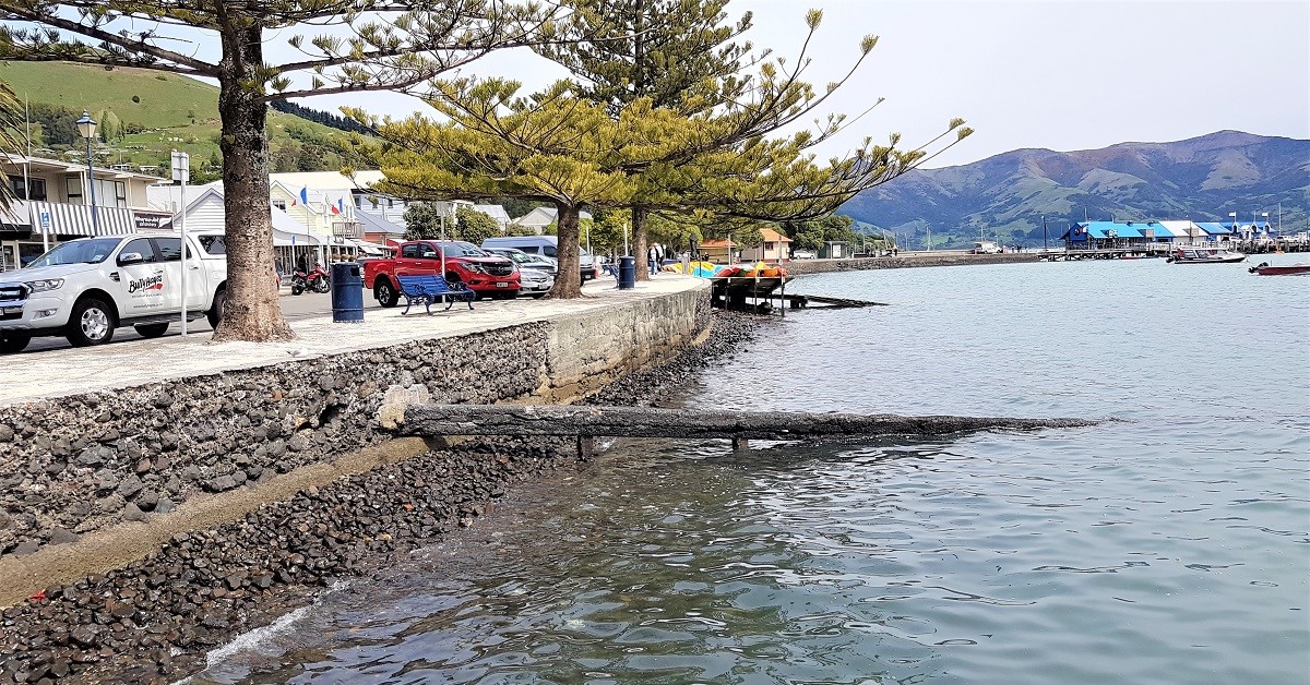 Seawall with mountains in background