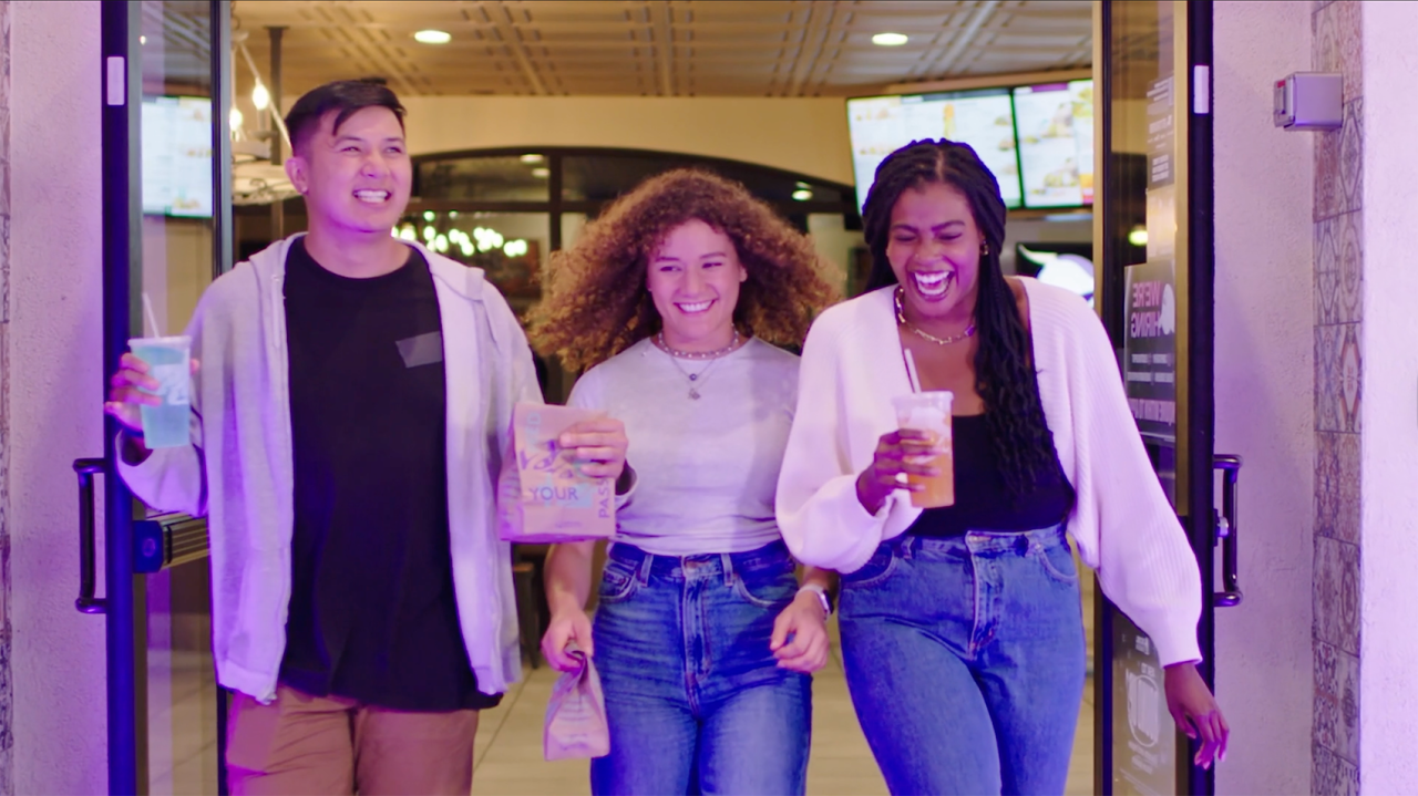 Three people laughing and walking together