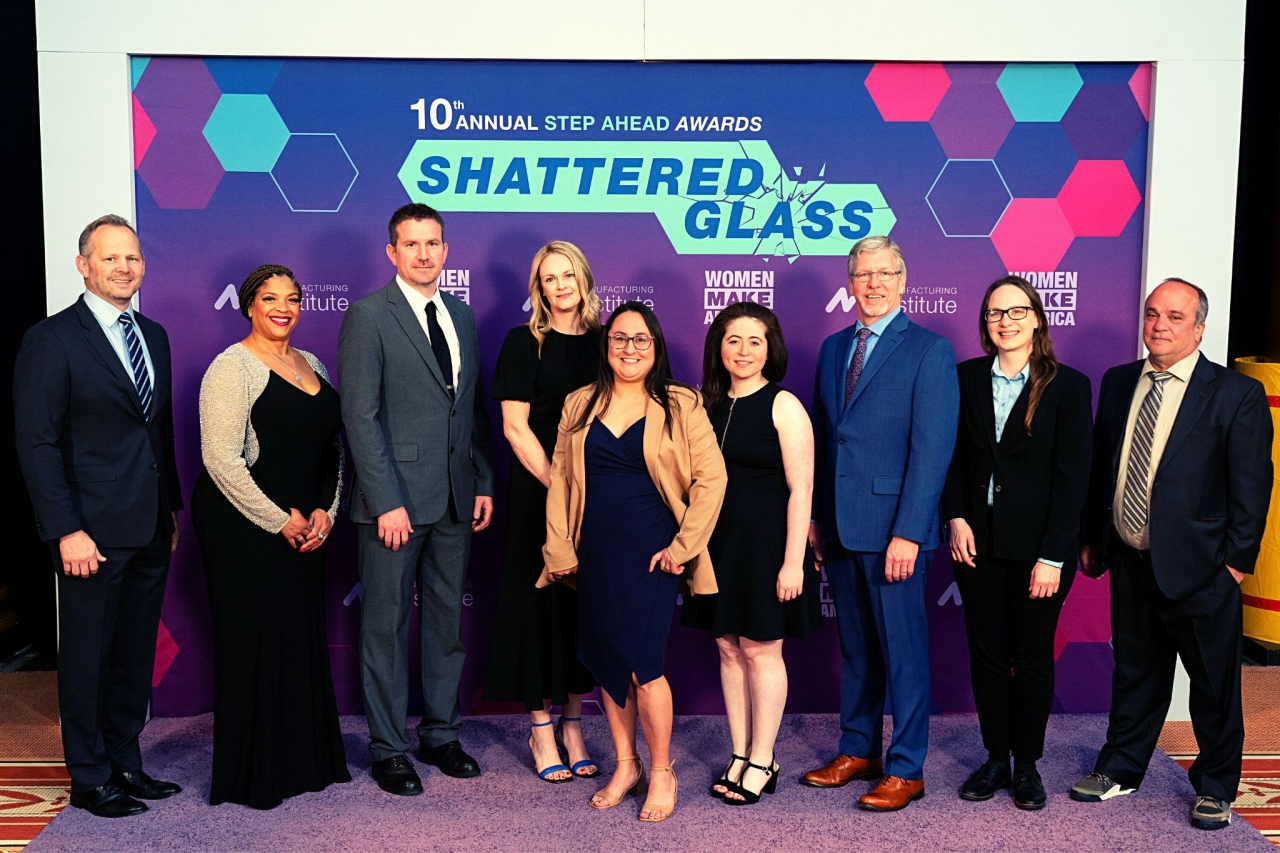 People Standing in front of a "Step Ahead Awards, Shattered Glass" Background