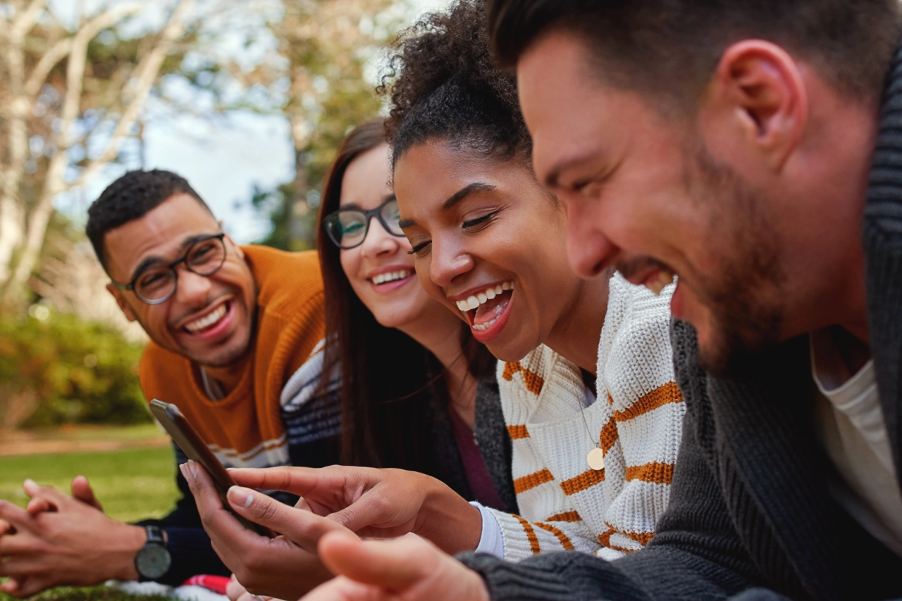 People outside smiling at their phone