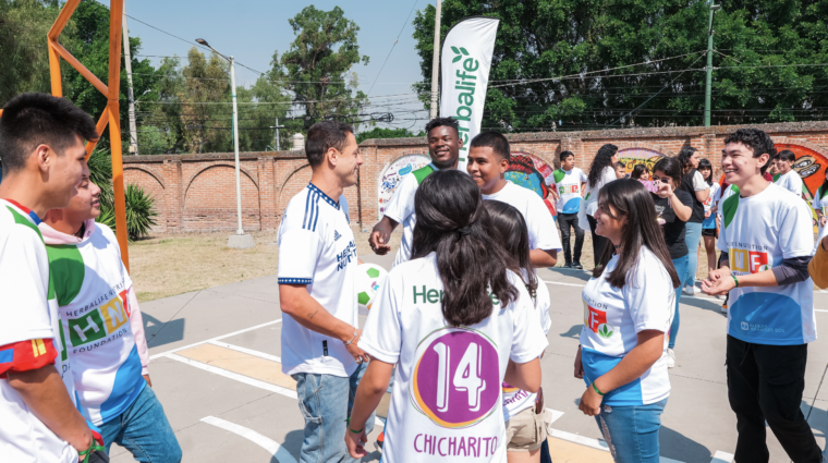 Javier Chicharito meeting with kids on a playground.