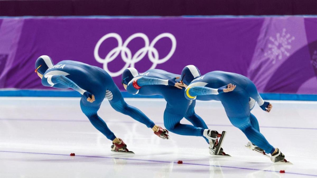 Three speed skaters on the ice.