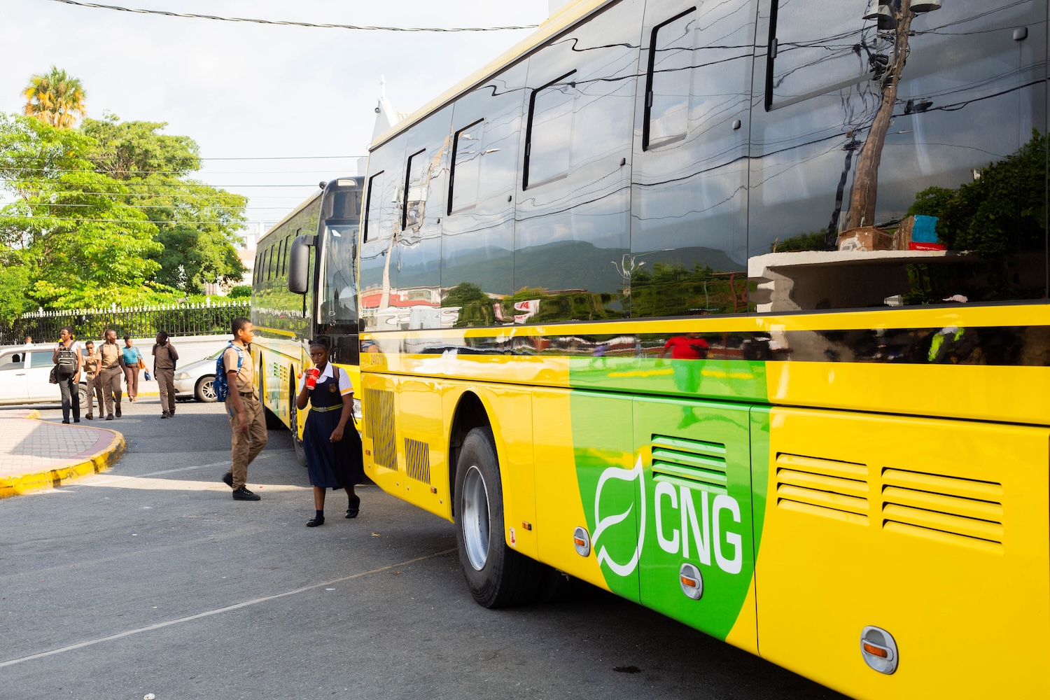 students getting onto CNG buses Jamaica