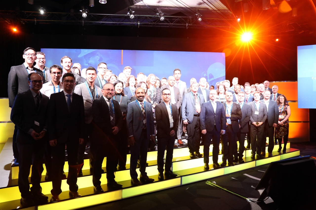 Suncor employees standing on a stage, wearing medals