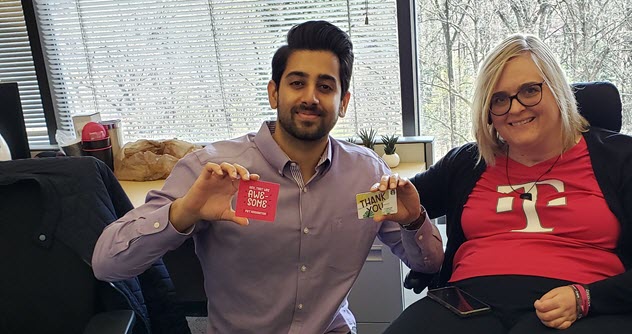 Susan Jolly and another person holding small cards in an office setting