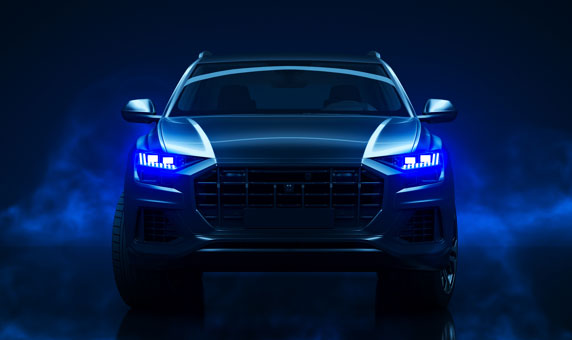 vehicle in a dark foggy space. Blue headlights glowing