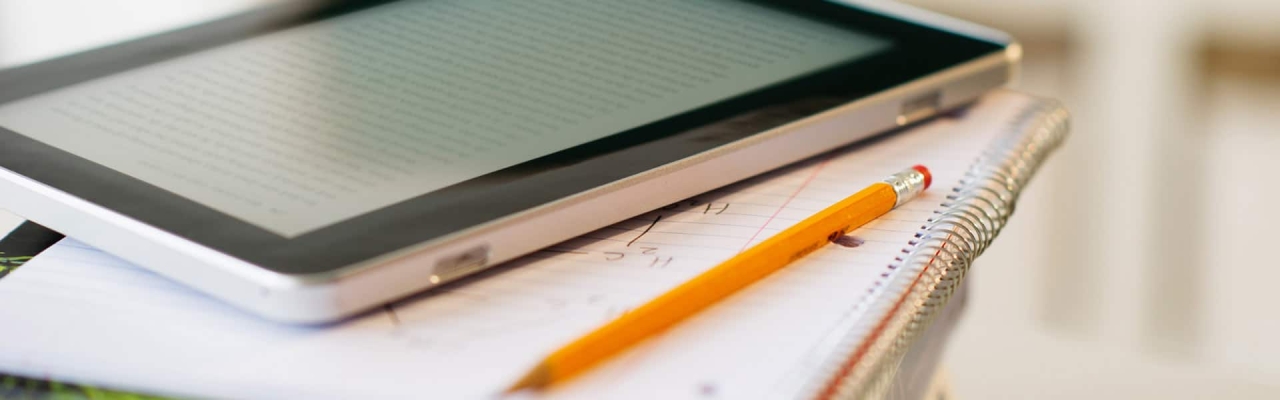 tablet and notebook with pencil