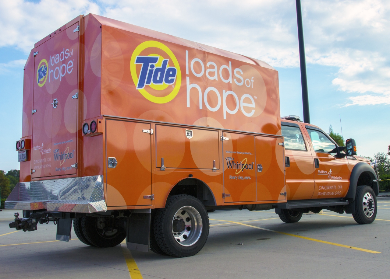 Orange truck and trailer, Tide Loads of Hope on the side