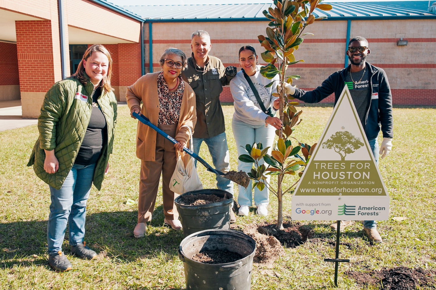 Volunteers and organization leaders plant a tree in Houston during the launch of the Tree Equity Score Analyzer.