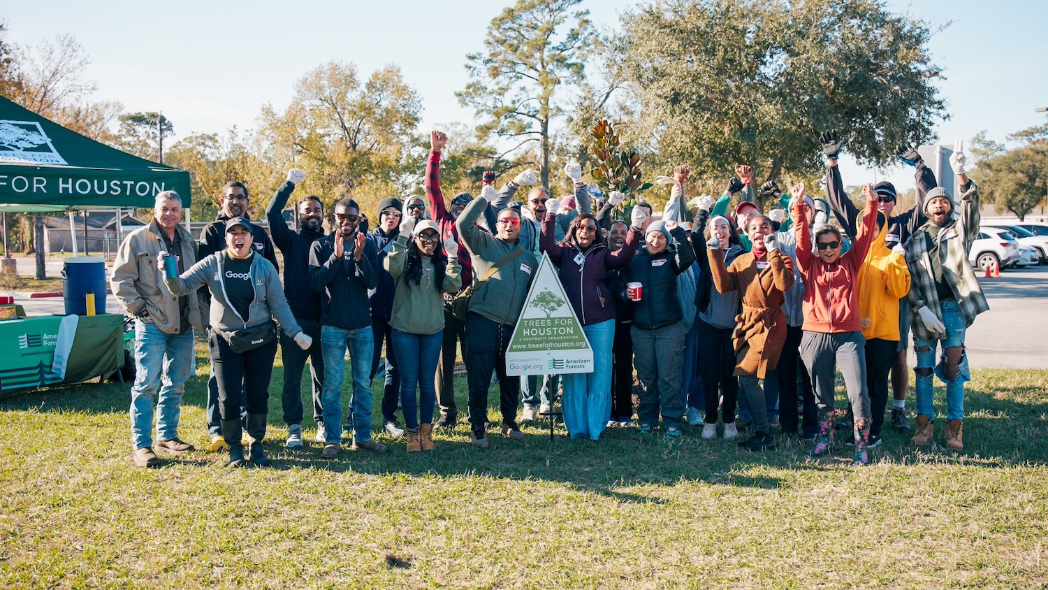 A large group of volunteers celebrates planting of 50 trees at Shadydale Elementary School in Houston — tree equity