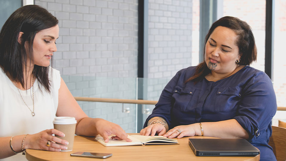 Two tetra tech employees reading a book