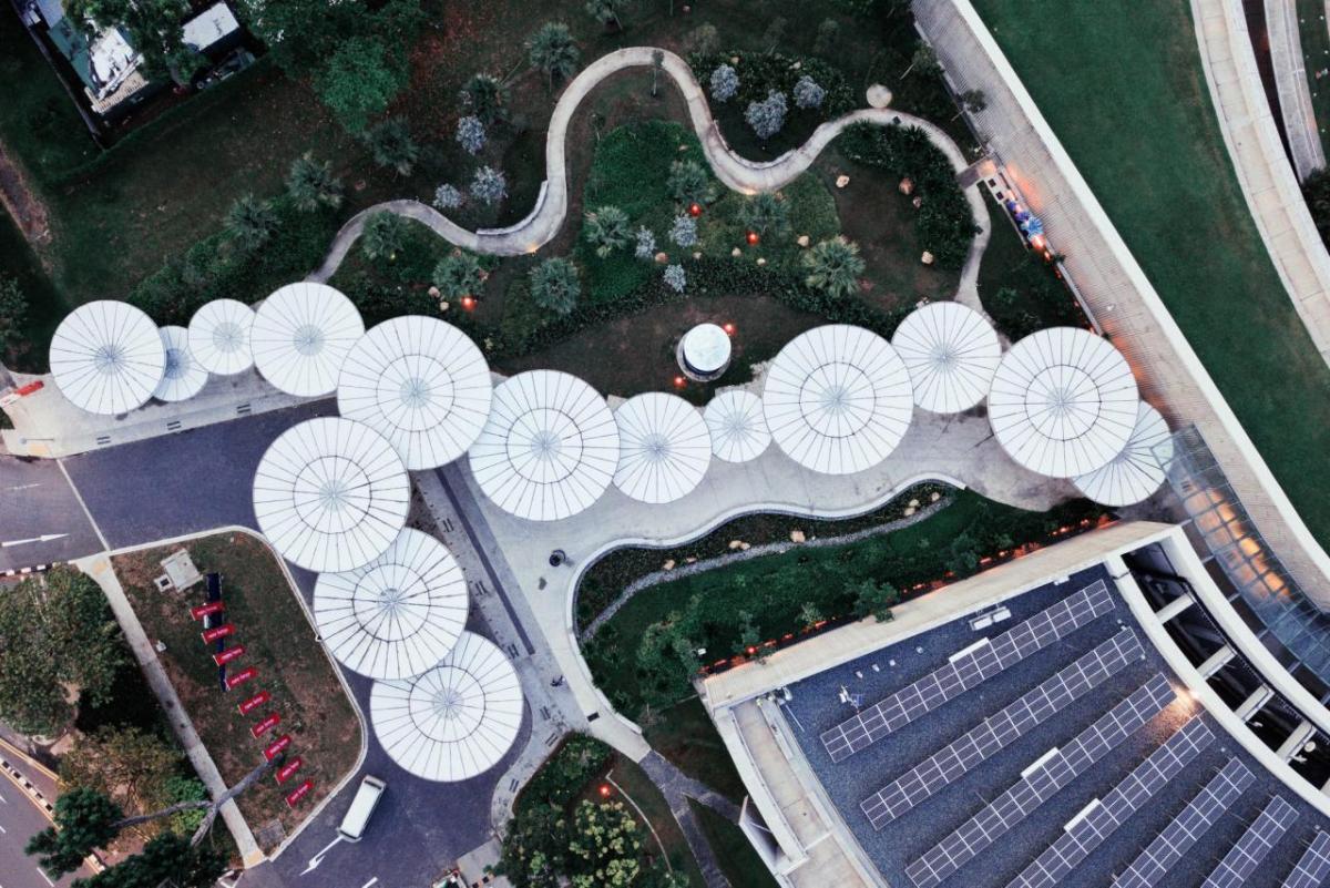 Aerial view of building and many circular objects along a path.