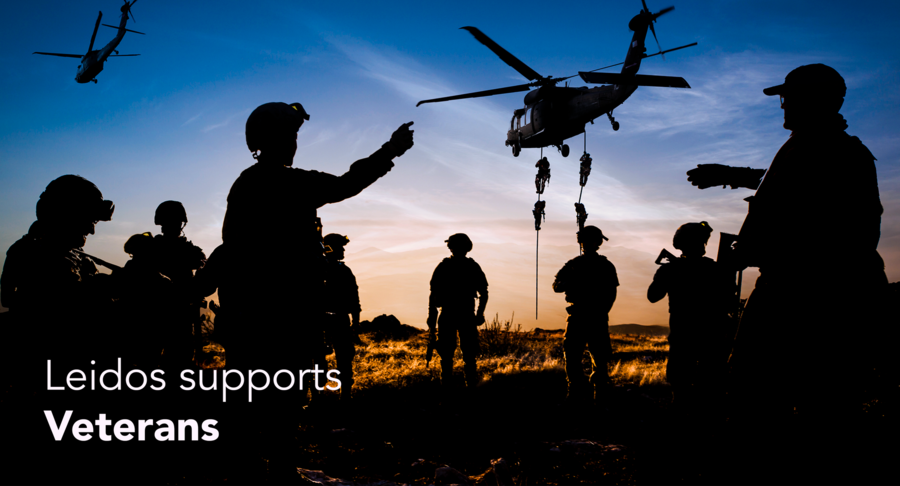 "Leidos Supports Veterans" over an image of silhouetted soldiers on the ground as some descend from a helicopter.
