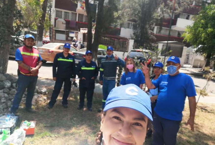 A group of people posed doing volunteer work.