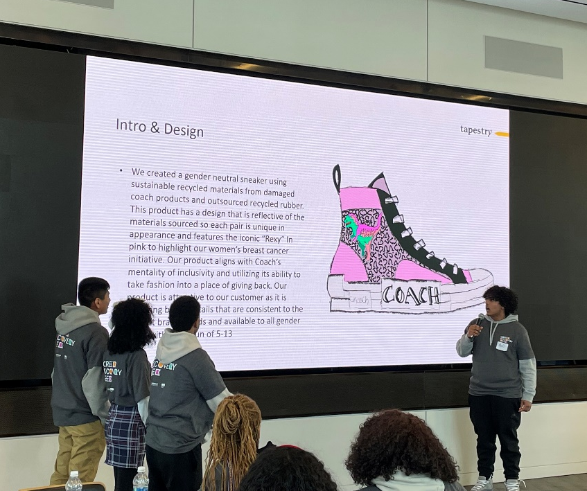 Four people in front of a large digital display, an audience looking on. "Intro & Design" and explination, a picture of a high-top sneaker with "Coach" on the sole.