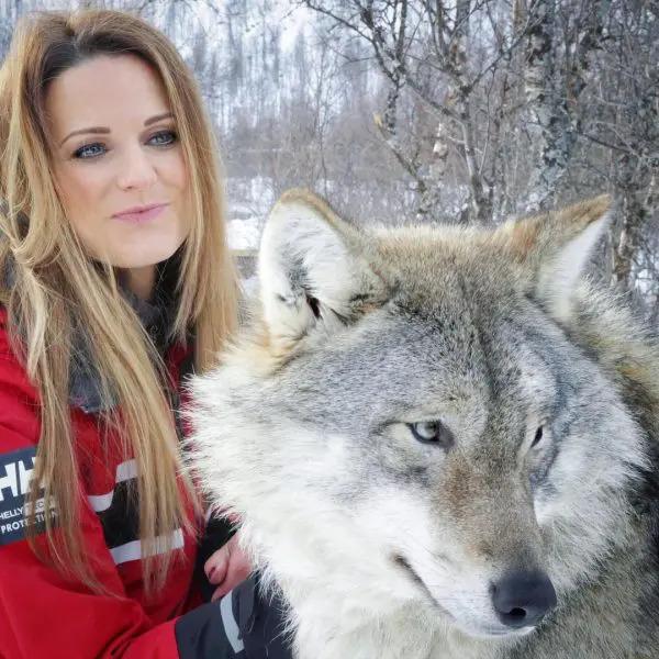 Catherine Capon petting a wolf