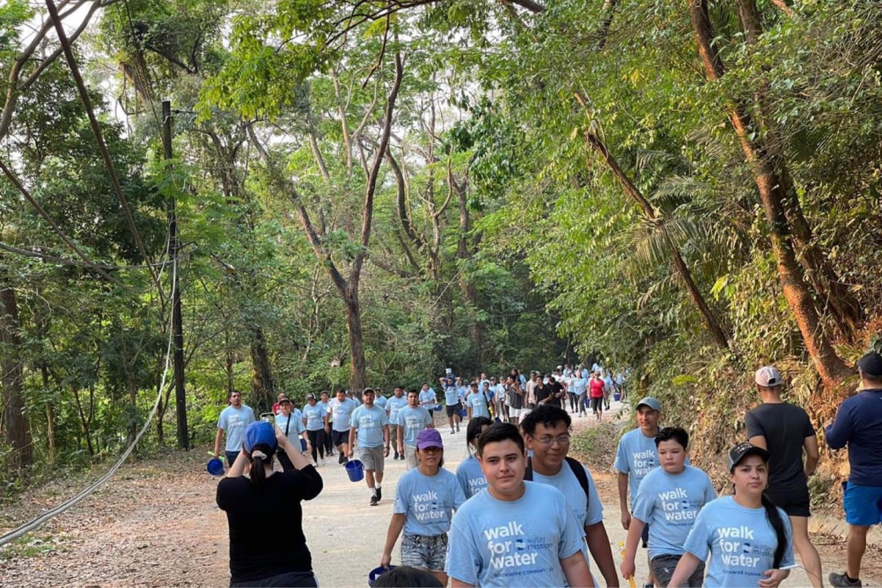 Participants walking the Walk for Water event through the woods