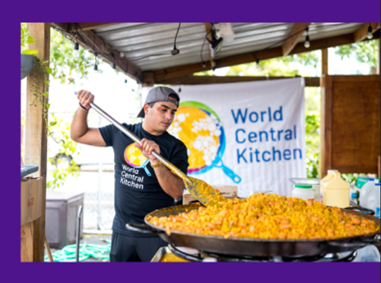 person cooking a large amount of food