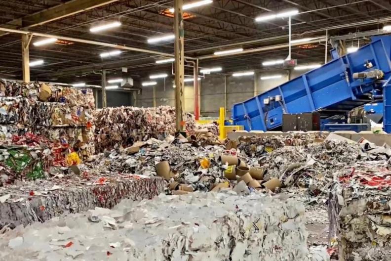 Truck dropping off a load at recycling facility 