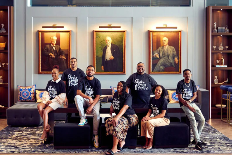 Group photo of 7 people wearing &quot;Shake Your Future&quot; shirts 