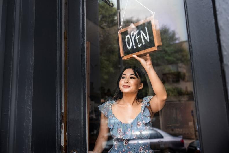 Small business owner shown opening her business. 