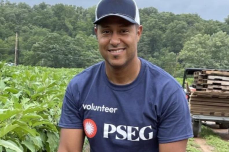 PSEG volunteer with a basket of eggplant 