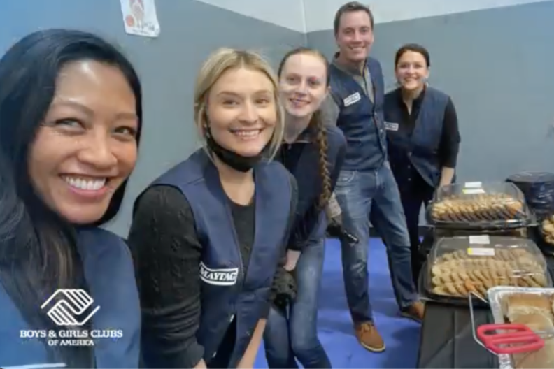 volunteers at tables of food 