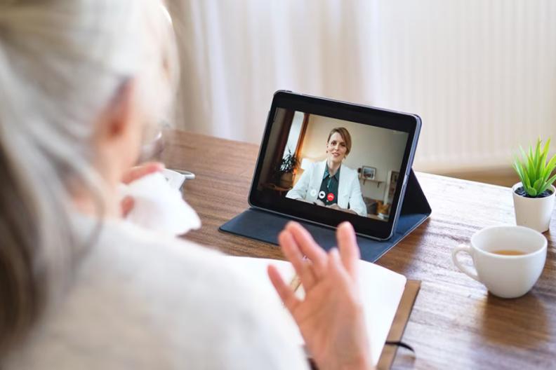 A person having a video call on a tablet device  