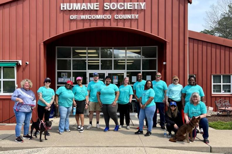  group of volunteers posed outside a building &quot;Humane Society&quot;. 