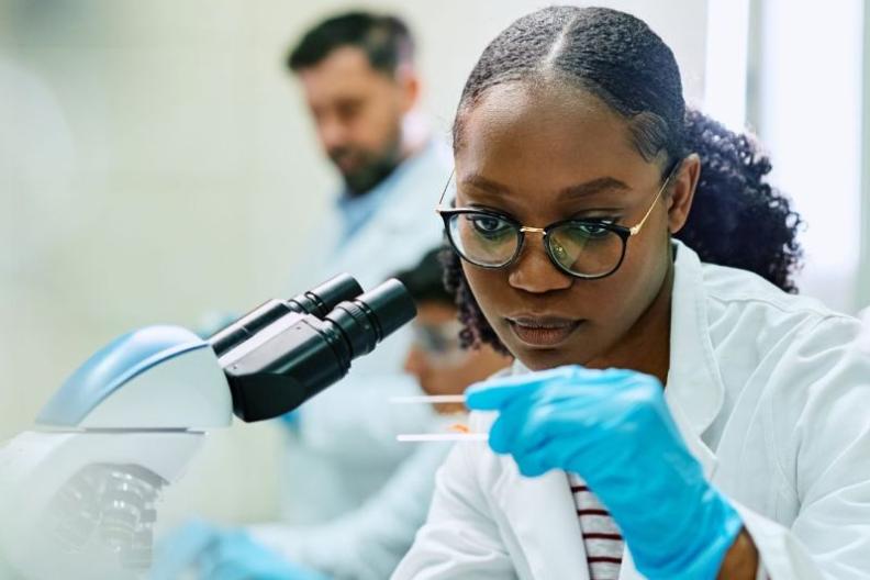A scientist examining a slide 