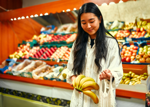 Asian woman shopping in the grocery store.