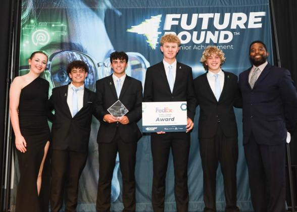 6 people on stage accepting an award