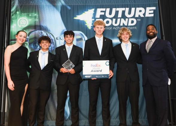 6 people on stage accepting an award