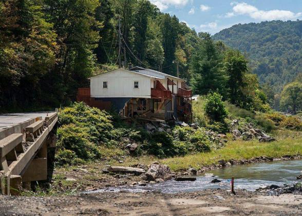 Photo of a house on a riverbank.