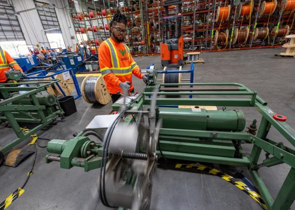 Wesco employee cutting spool wire.