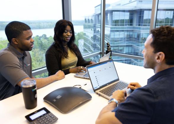 employees collaborating by windows