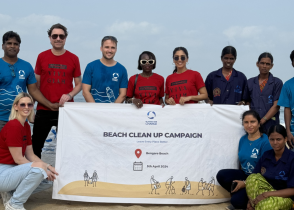 Volunteers pose with Beach clean up campaign banner