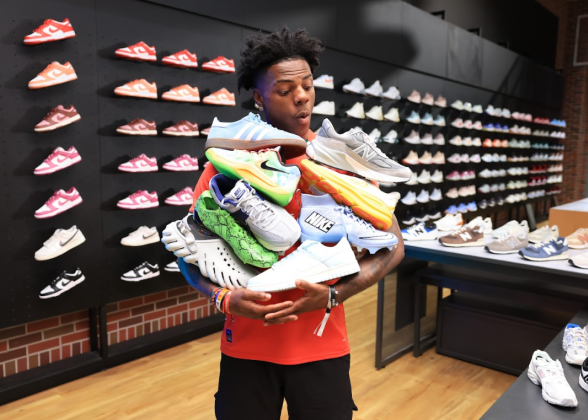 IShow Speed shown with an armful of sneakers.