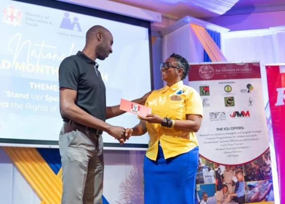 Restaurants of Jamaica Brand Manager Andrei Roper (left) presents a symbolic cheque to National Child Month Committee Chairperson Nicole Patrick-Shaw, during the National Child Month Launch.