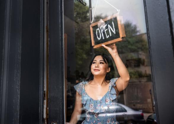Small business owner shown opening her business.