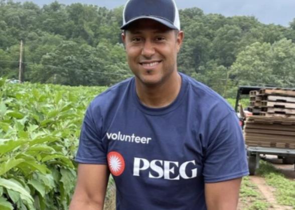 PSEG volunteer with a basket of eggplant