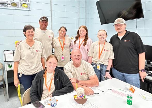 A group of 8 people posing in a cafeteria