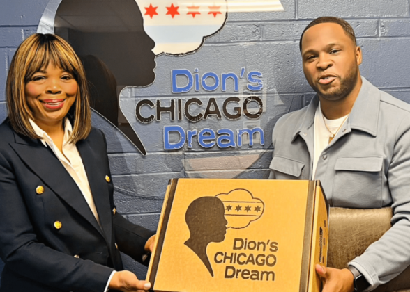Two people holding a box &quot;Dion&#039;s Chicago Dream&quot; on the front and on the wall behind them.