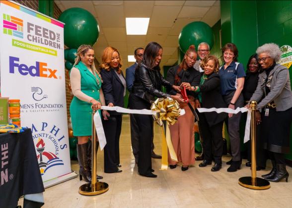 People performing a ribbon cutting ceremony