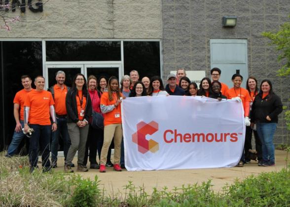 A group of employees posed outside with a &quot;Chemours&quot; banner.