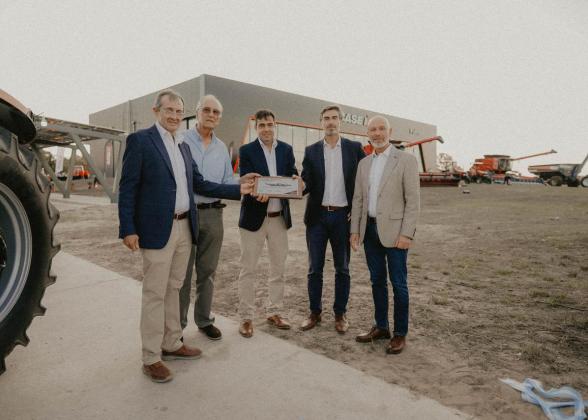 Five people standing together outside a dealership