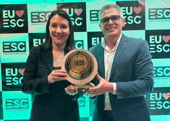 two people holding award at event